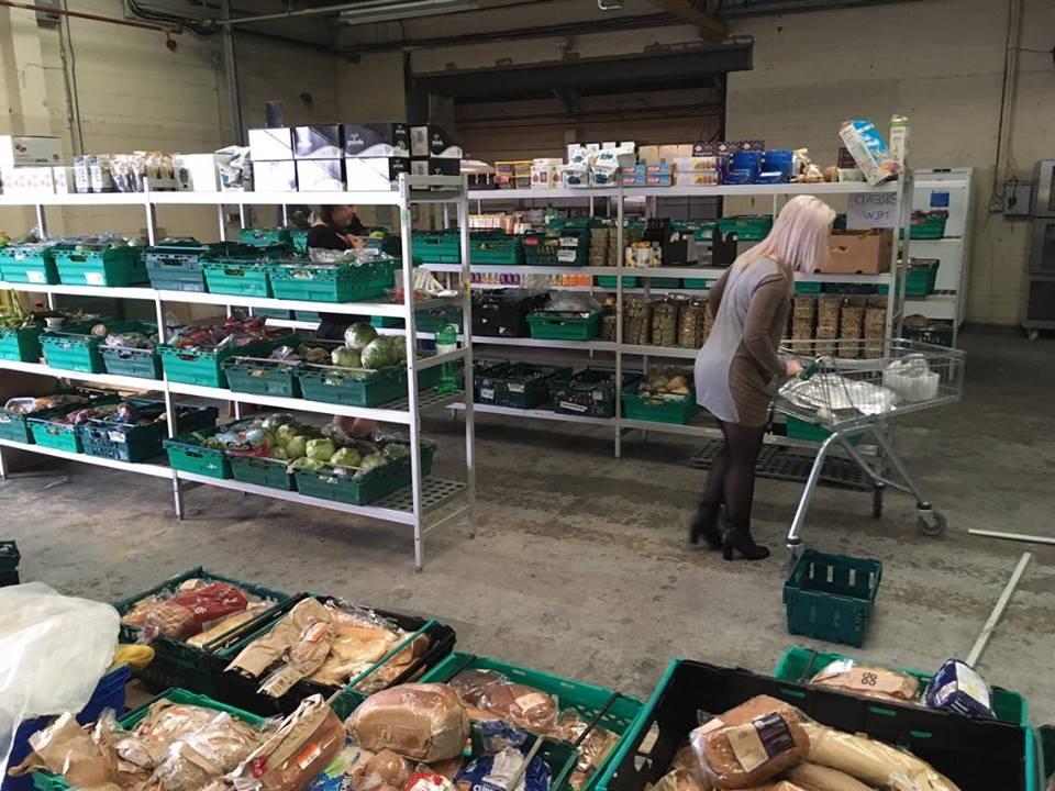 A shopper browses the shelves in the UK’s first food waste supermarket The Real Junk Food Project