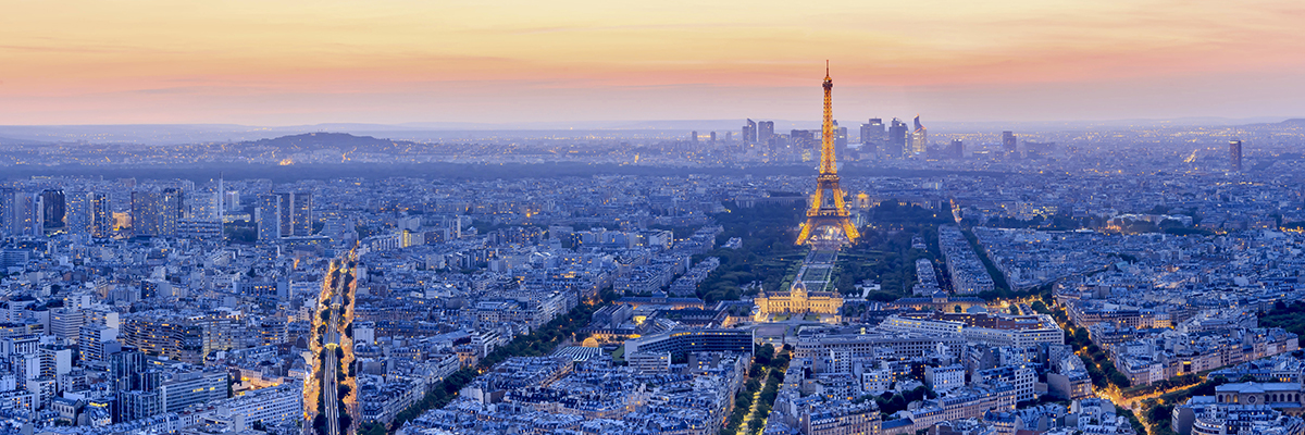 PARIS - JUNE 21: Eiffel Tower brightly illuminated at dusk on JUNE 21, 2014 in Paris. The Eiffel tower is the most visited monument of France.